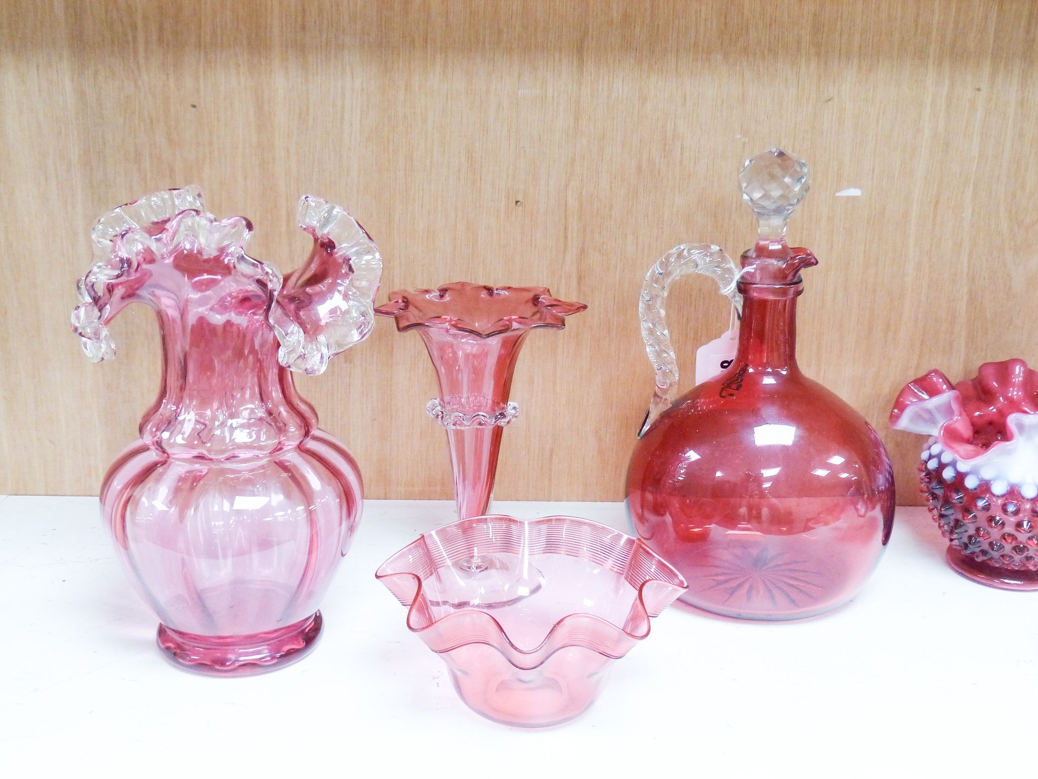 A group of Victorian Cranberry glass dishes, two vases and a Claret jug, tallest 23.5 cm (7)